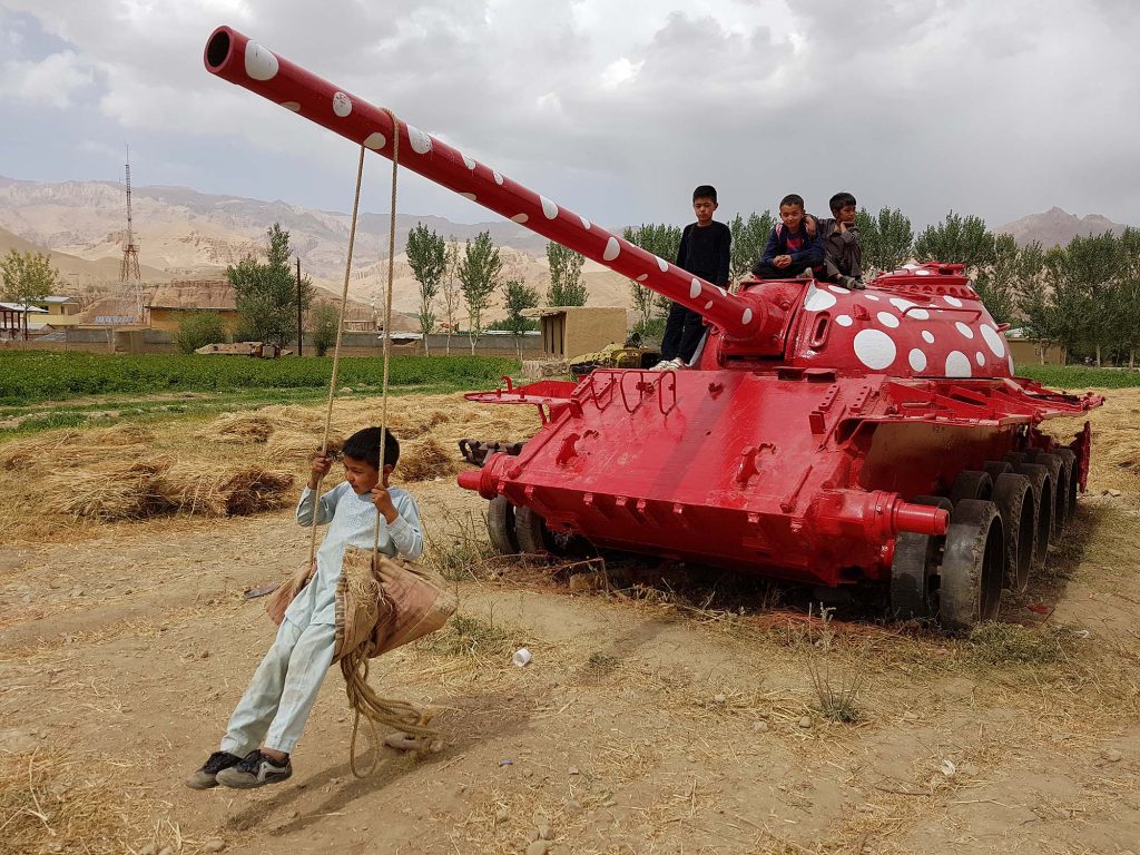Close-up of red polka-dot Soviet military tank with children
