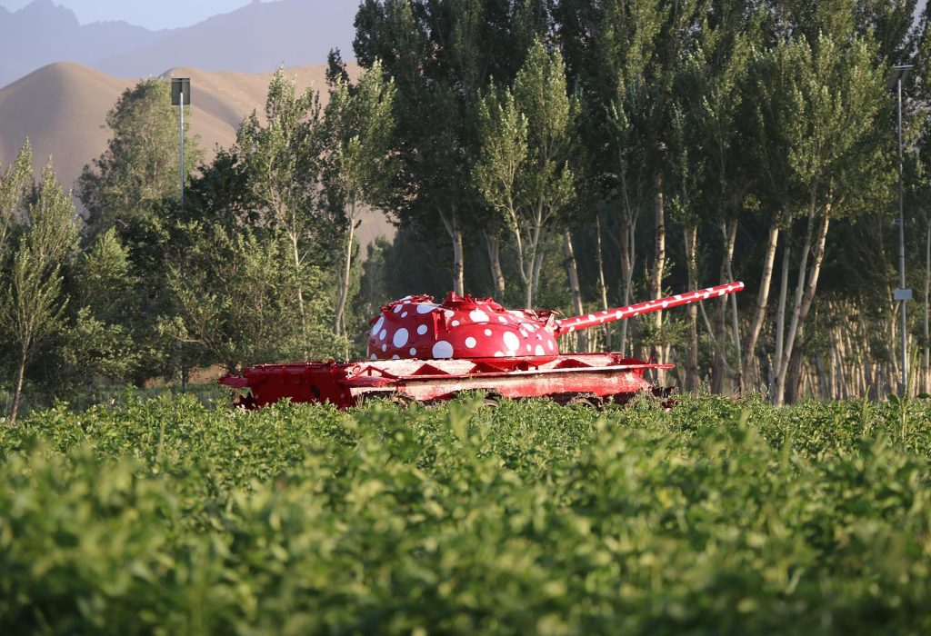 Red Soviet military tank with white polka dots in Bamian