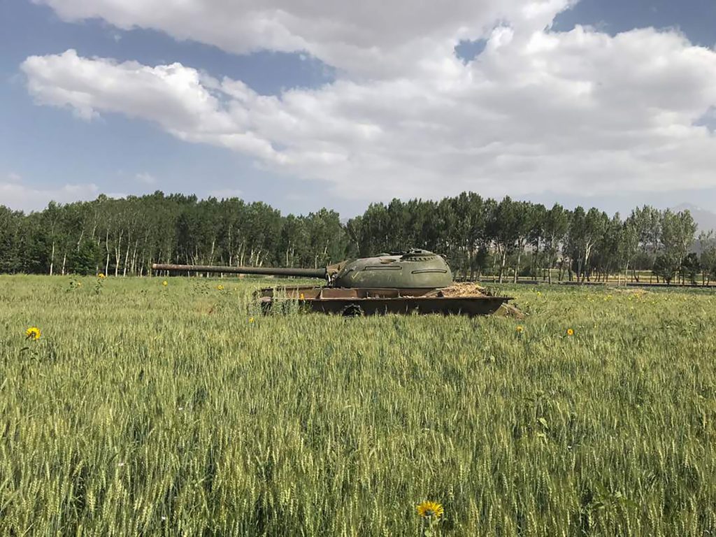 Unpainted Soviet military tank in a wheat field in Bamian