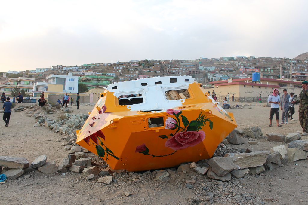 Close-up of orange Soviet military vehicle with red flower motifs